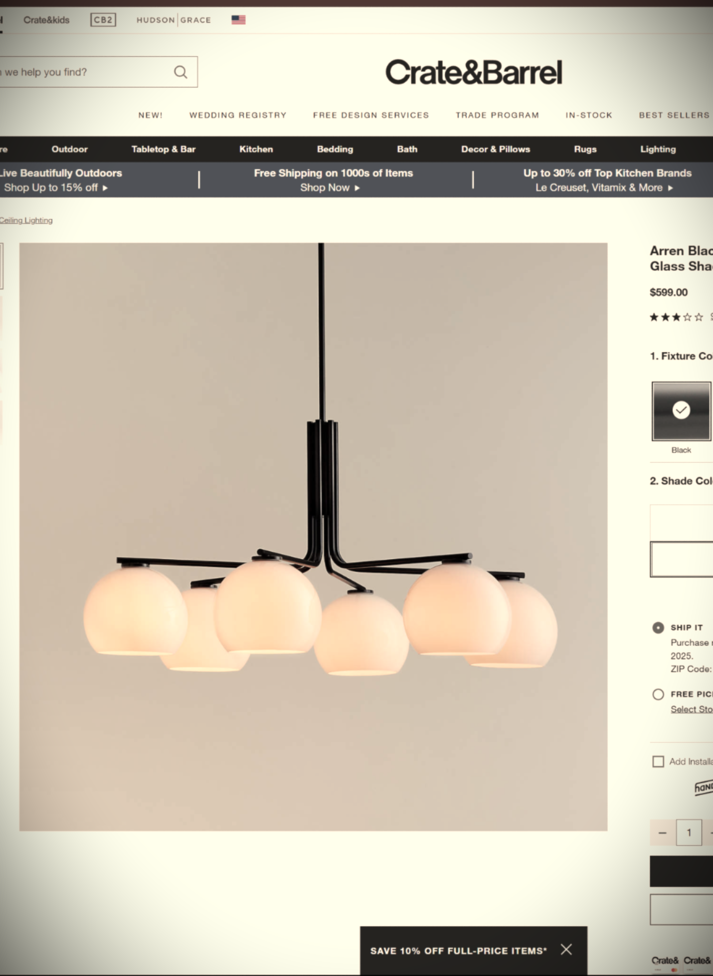 Modern black chandelier with six round glass shades on Crate & Barrel website.