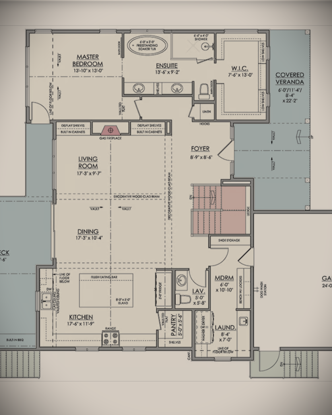 Floor plan of a house showing a kitchen, dining room, living room, master bedroom with ensuite and walk-in closet, guest bedroom, bathrooms, laundry room, foyer, covered veranda, staircases, and storage areas.