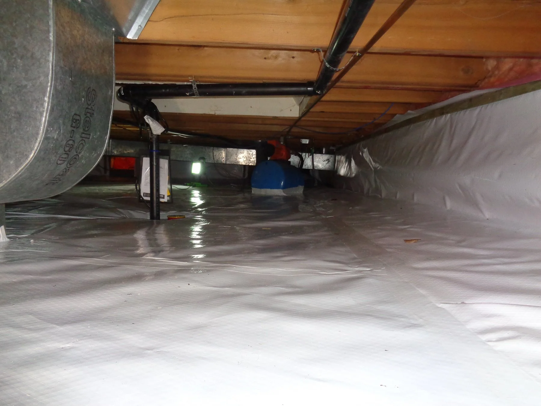 Encapsulated crawl space with ductwork and pipes