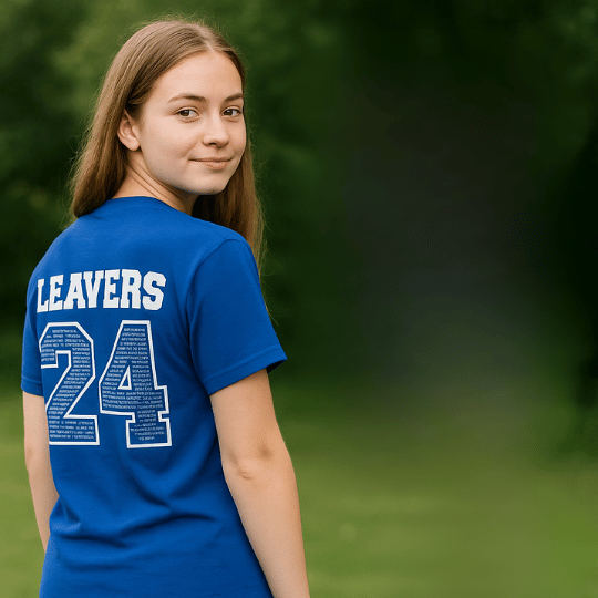 A young woman with long brown hair wearing a blue sports jersey with the name 'Leavers' and number 24 on the back, standing outdoors with a blurred green background.