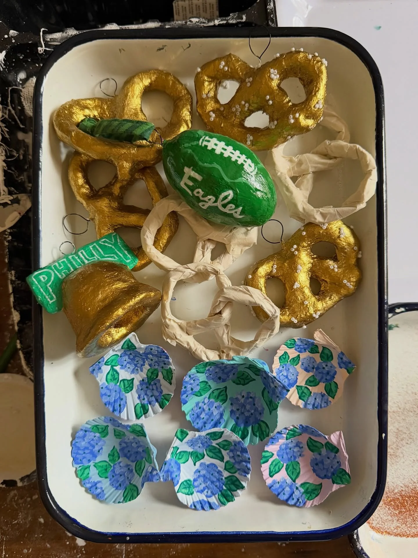 Salting gold plaster pretzels, painting hydrangeas on seashells, making footballs out of Easter eggs - the studio is a mess but the &ldquo;work&rdquo; is fun. 💖🎄
