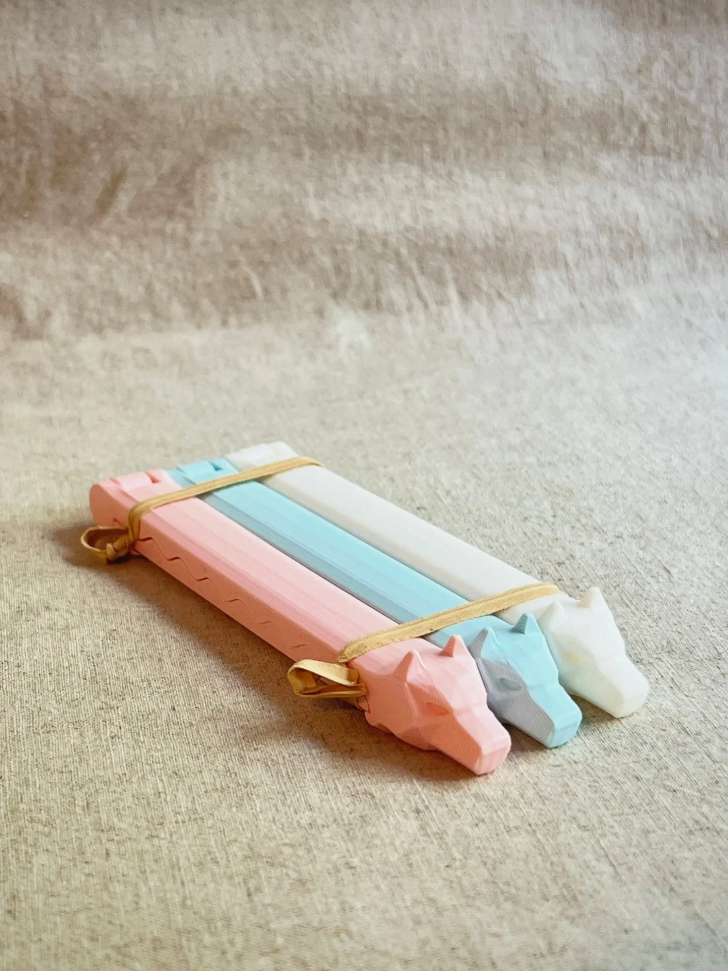 The Watch Dogs bag clips in pink,  blue and white, bundled together.