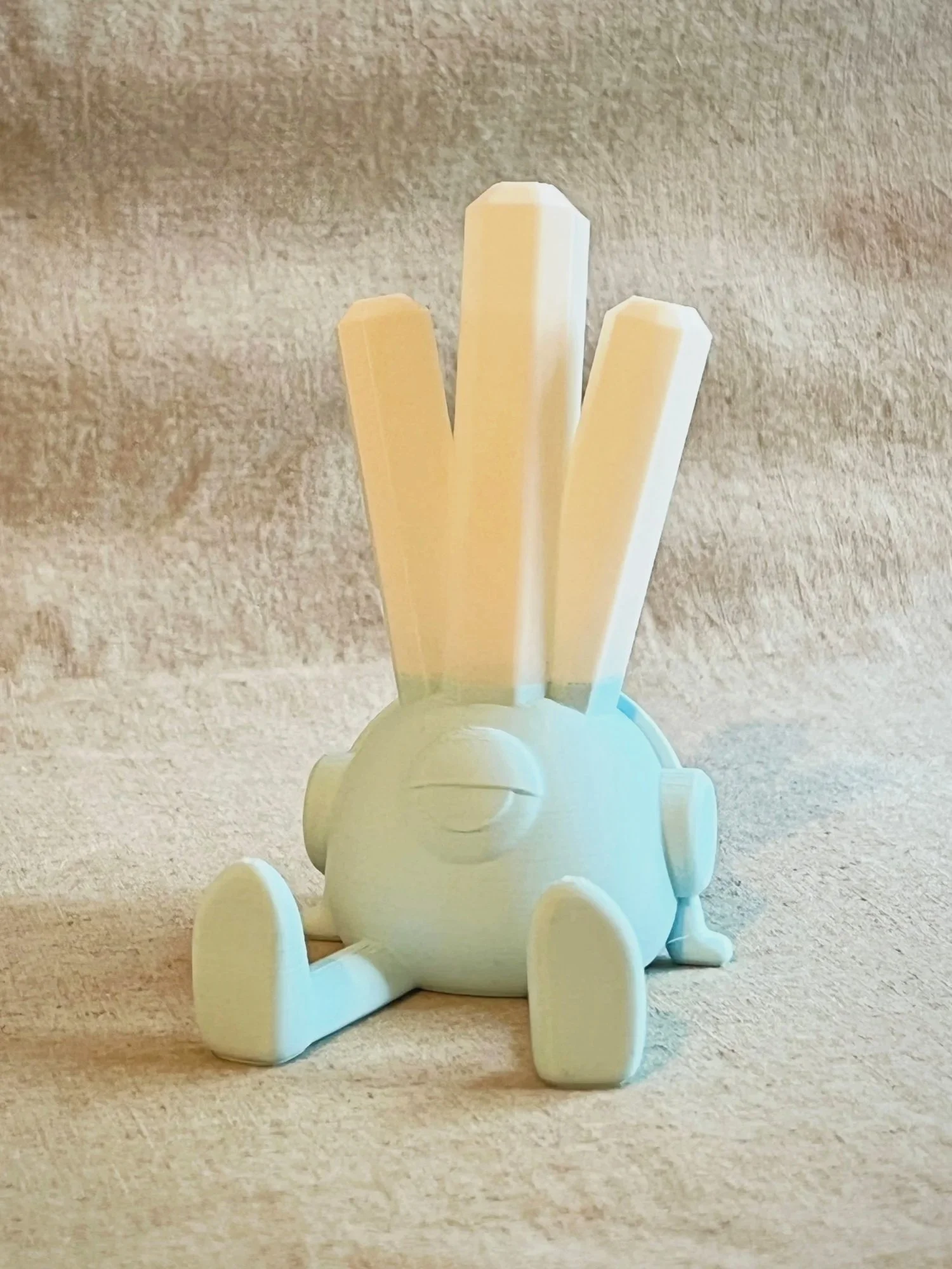 Blue Terry the Enjoyer phone stand with white crystal spikes.