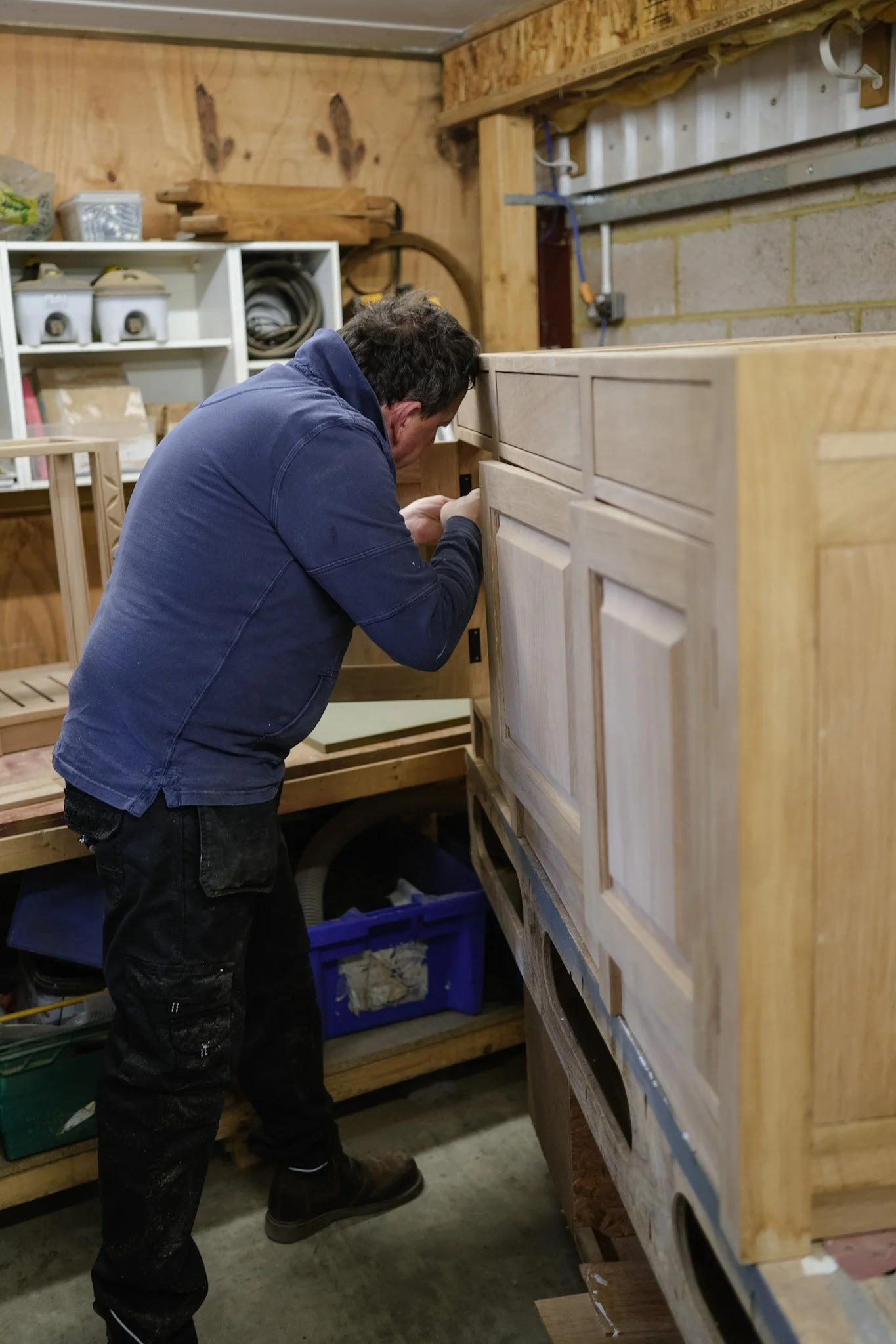 Craftsman working on wooden furniture in workshop