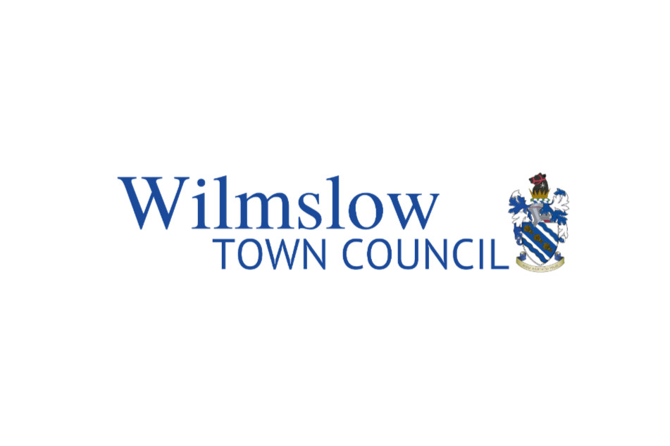 Logo of Wilmslow Town Council with a coat of arms featuring a shield, helmet, and floral elements.