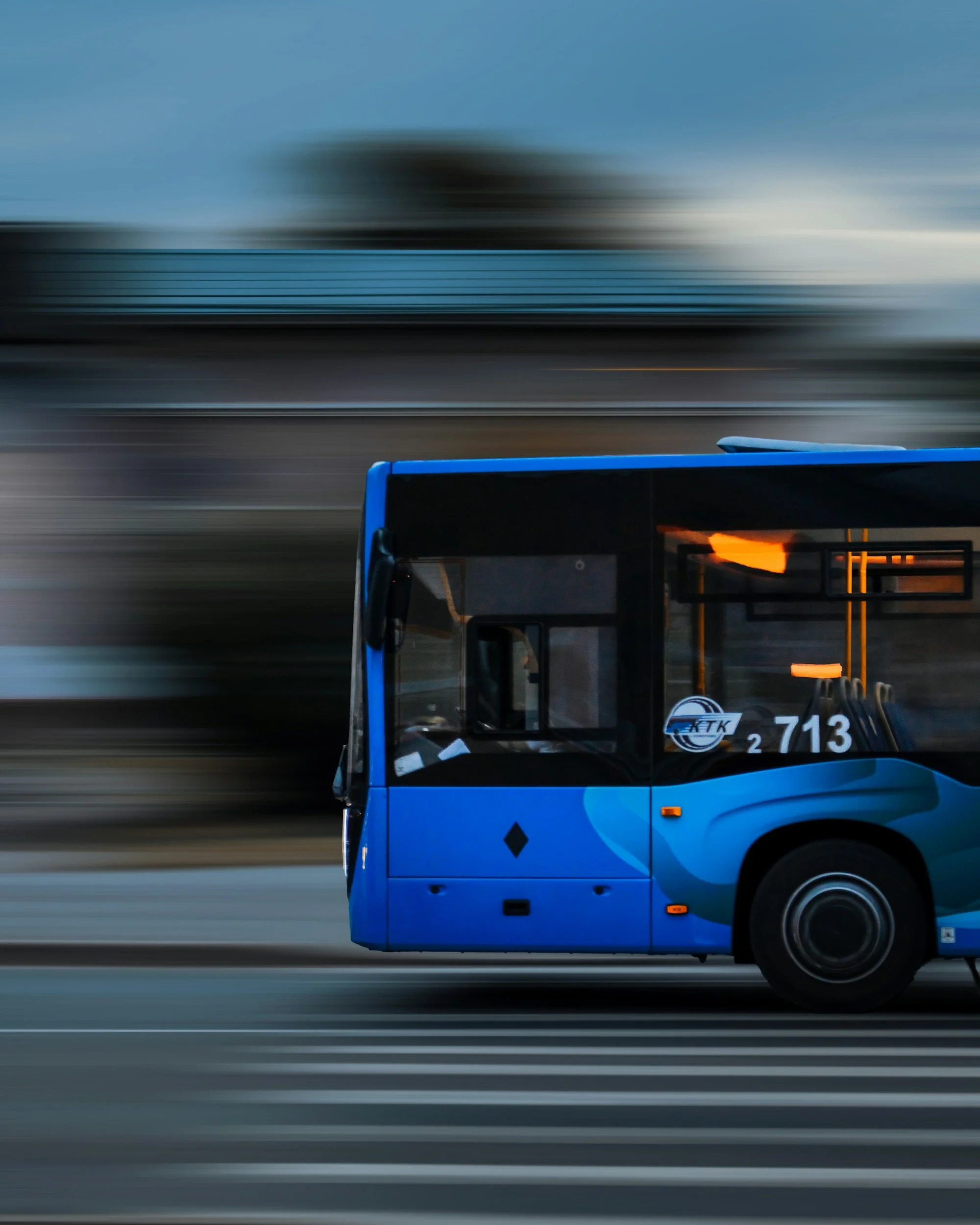 PlaceholderBlue city transit bus in motion on an urban street