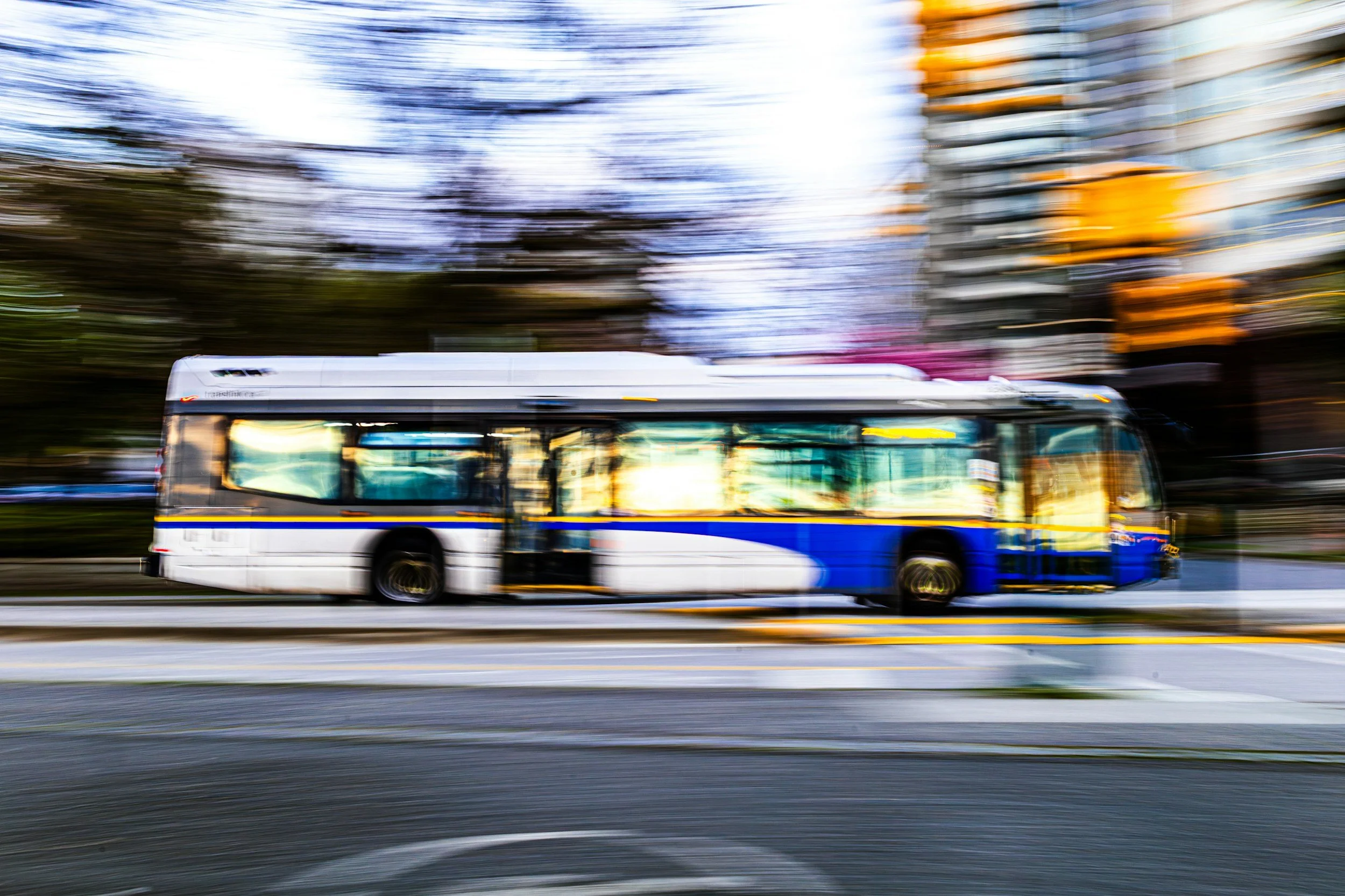 City transit bus in motion on an urban street