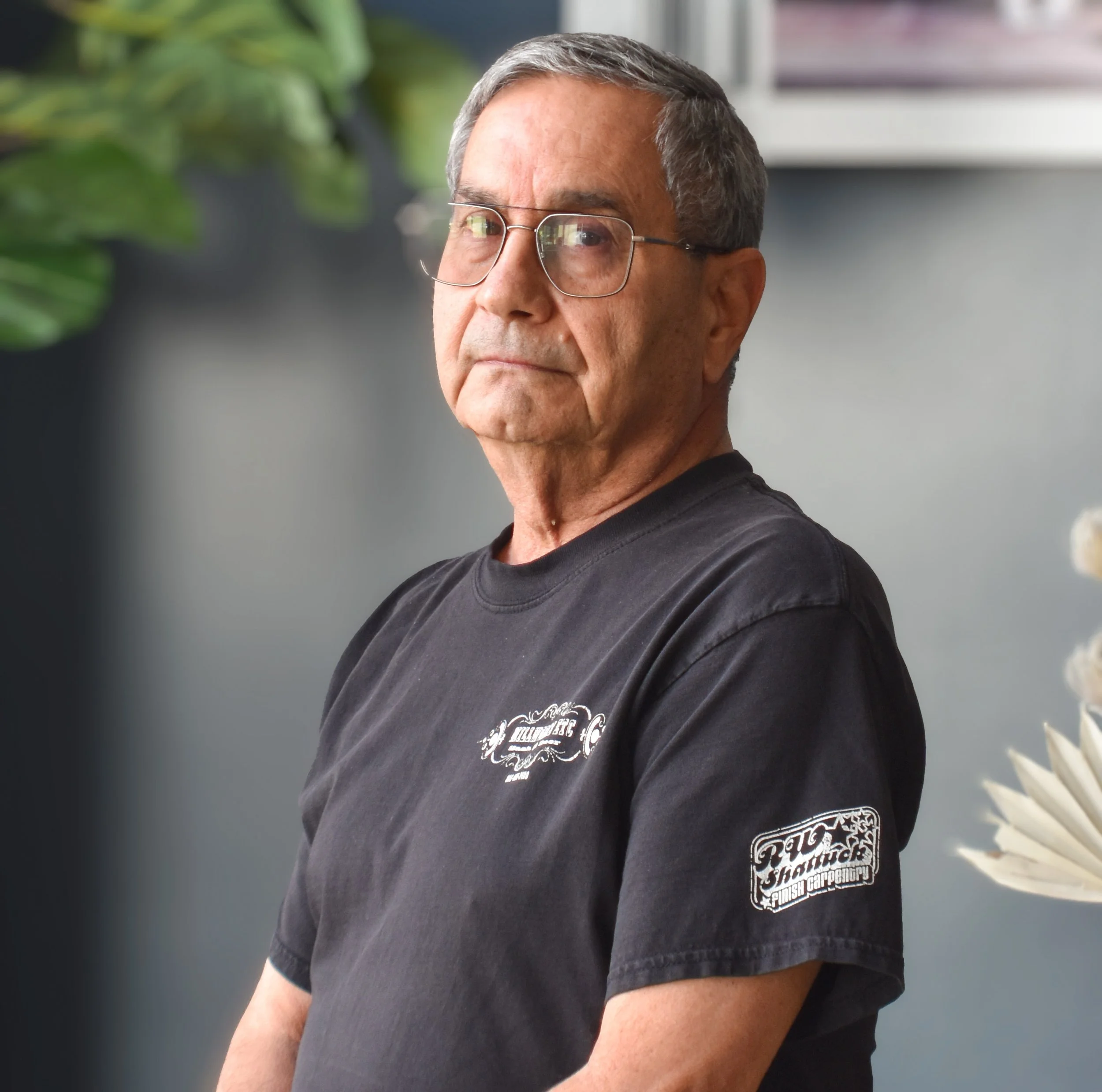 Silhouette of a man with a suit and tie, face not visible, in grayscale.