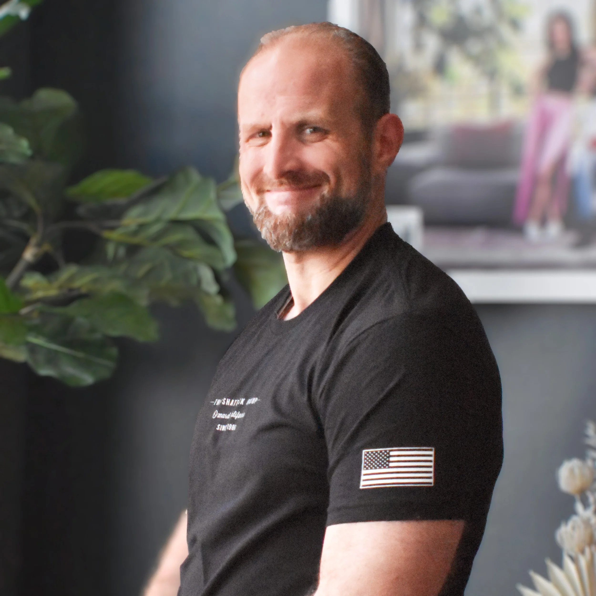 A grayscale, faceless silhouette of a man in a suit with no facial features.