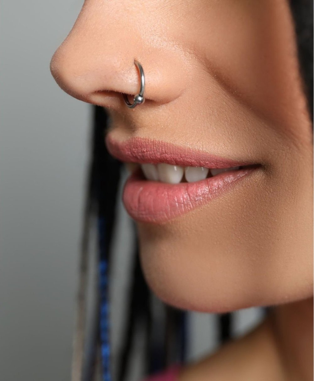 Close-up photograph of a nose piercing