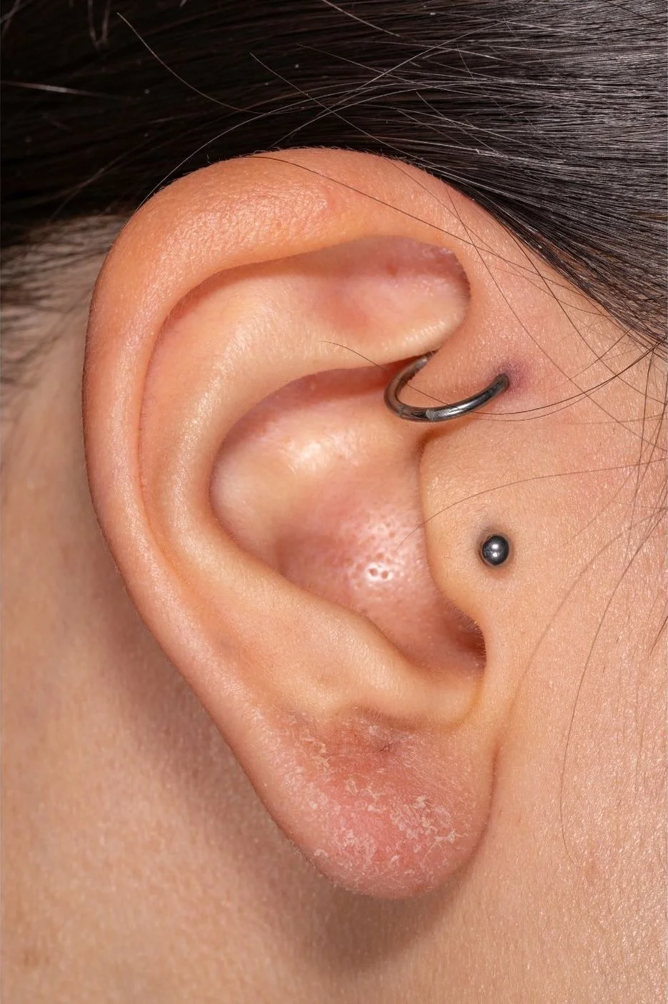 Close-up photograph of a daith piercing