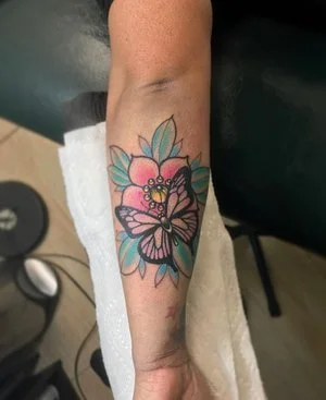 close-up photograph of a butterfly and flower custom flash tattoos