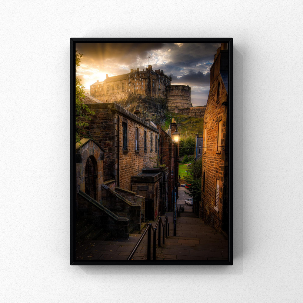Edinburgh Castle above historic stone streets in warm evening light