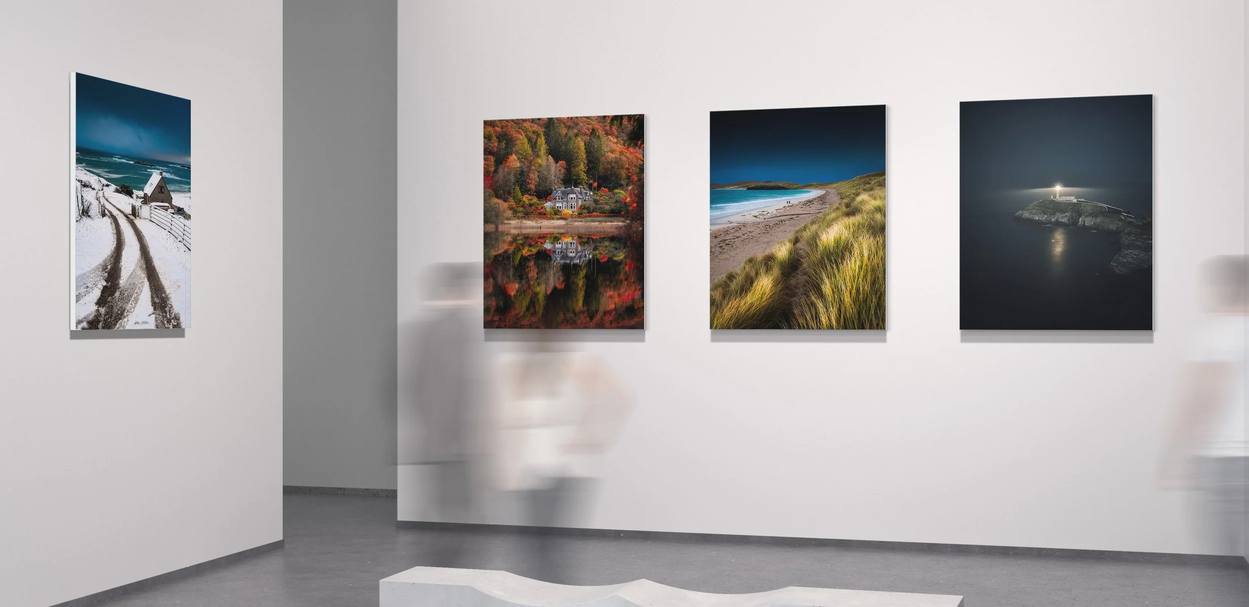 Gallery of four James Alroca landscape photographs on a white wall in an art gallery.