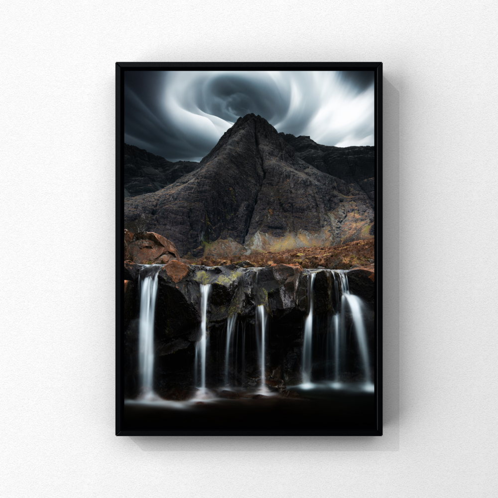 Waterfalls at the Fairy Pools beneath dramatic mountain clouds on the Isle of Skye