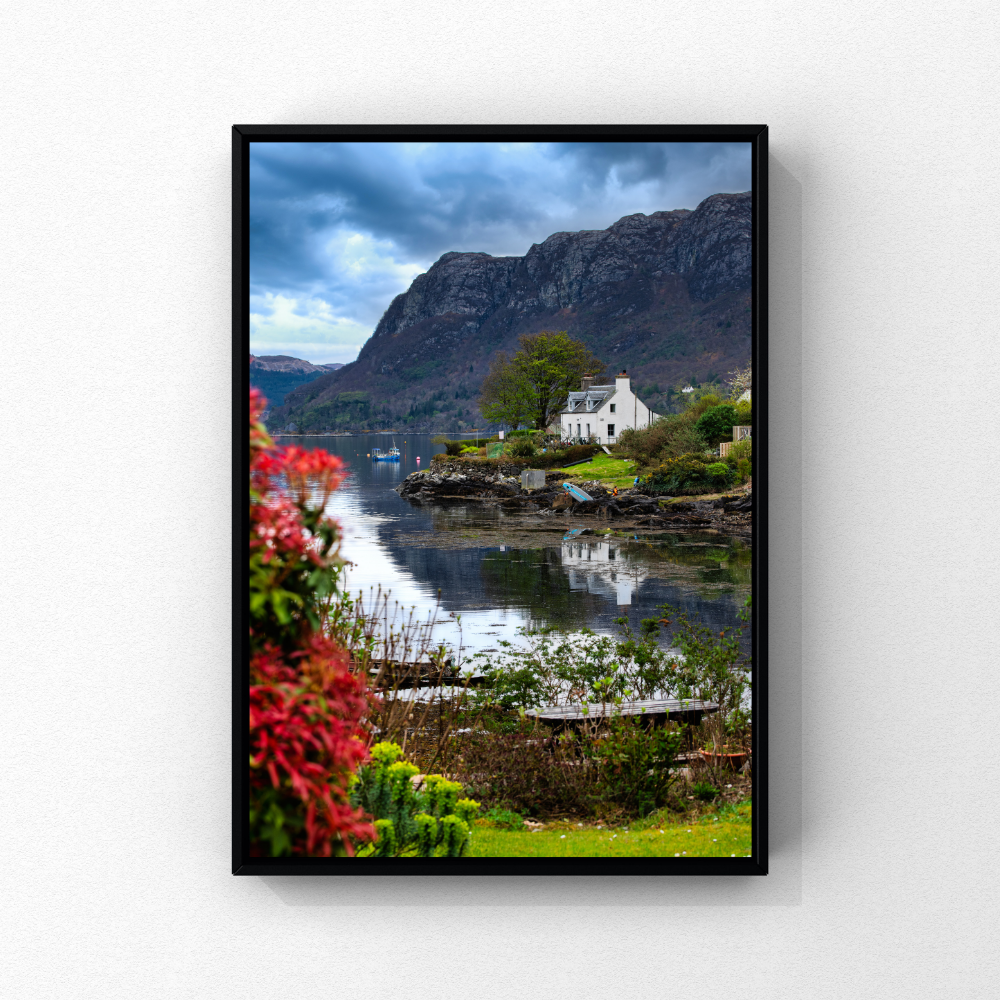 Colourful flowers and waterfront houses beneath the hills at Plockton, Scotland