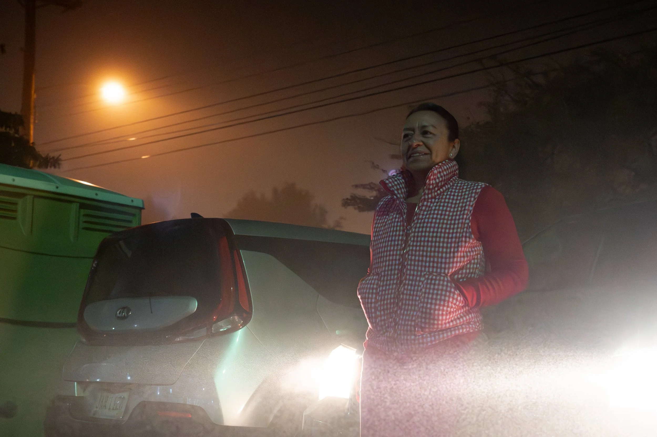 Elida, who is uninsured and from El Salvador, waits in the fog in front of East High School for the Remote Area Medical clinic to open in Columbus, Ohio, Nov. 8, 2025. She has been waiting in the parking lot since 4 a.m. to receive dental treatment; 