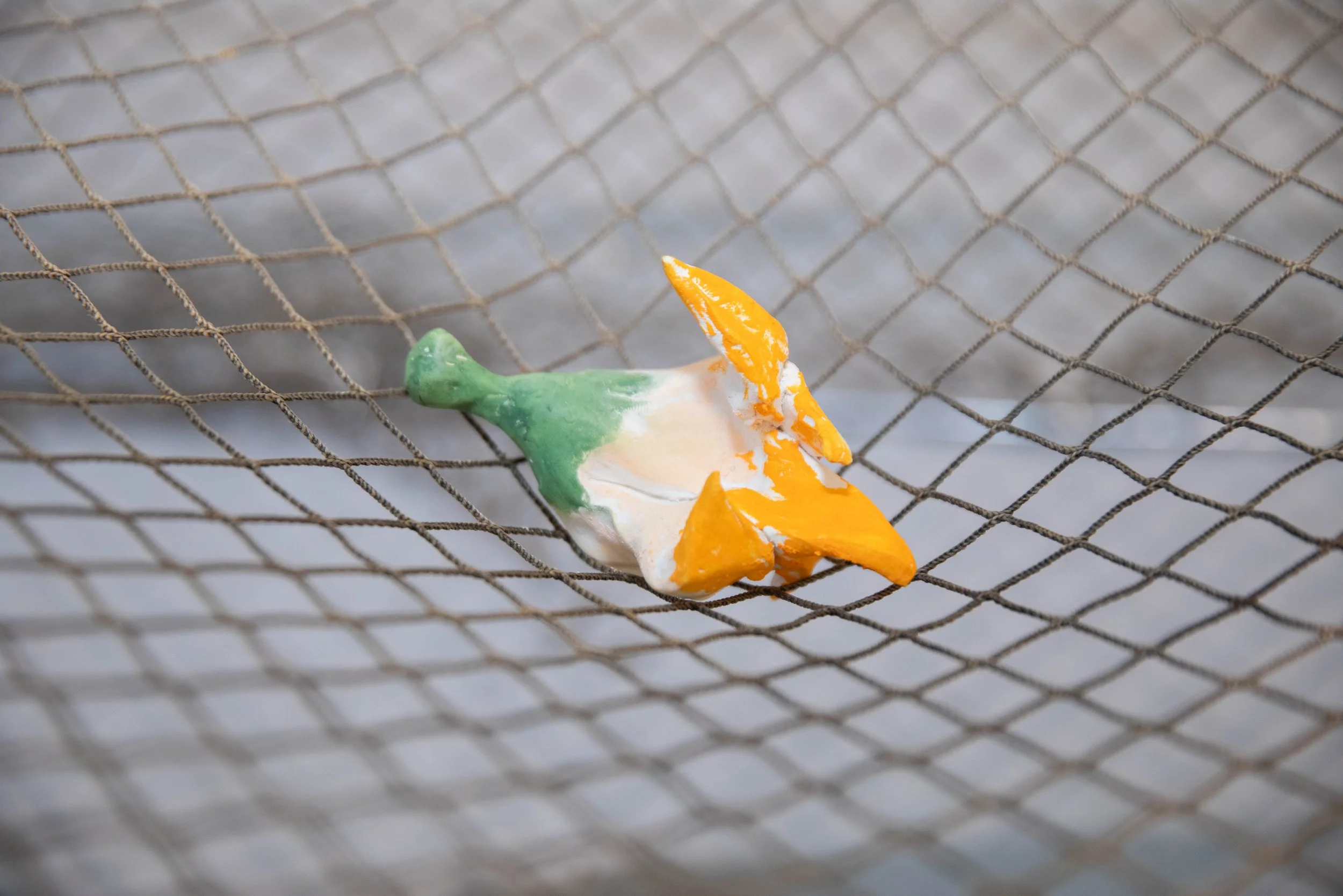 Charlie Lambert
Shhhh (detail)
2025
Ceramic, glaze, metal, fishing net, raw clay from Cumurxatiba, Bahia, oil pastel
Dimensions variable 
