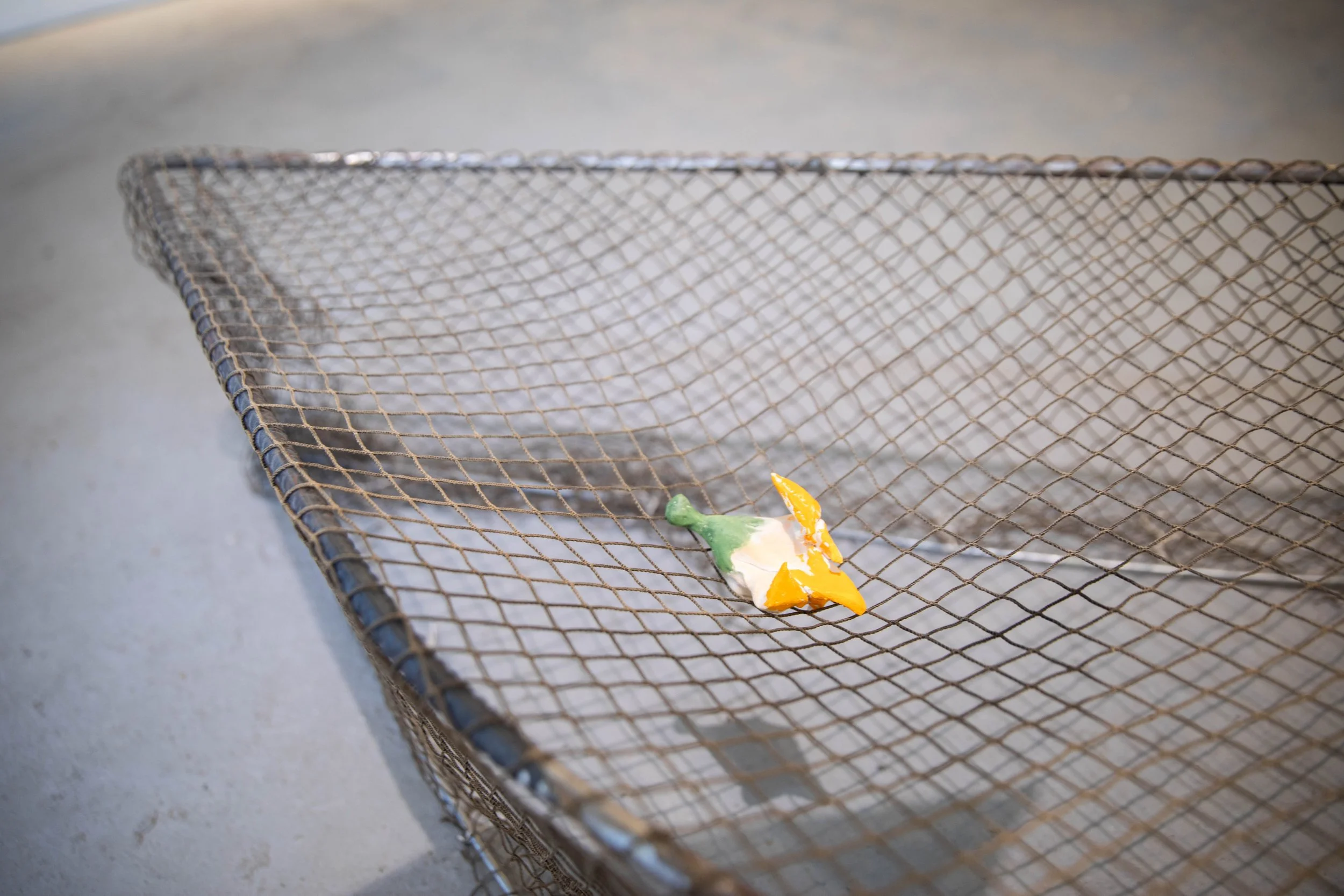 Charlie Lambert
Shhhh (detail)
2025
Ceramic, glaze, metal, fishing net, raw clay from Cumurxatiba, Bahia, oil pastel
Dimensions variable 
