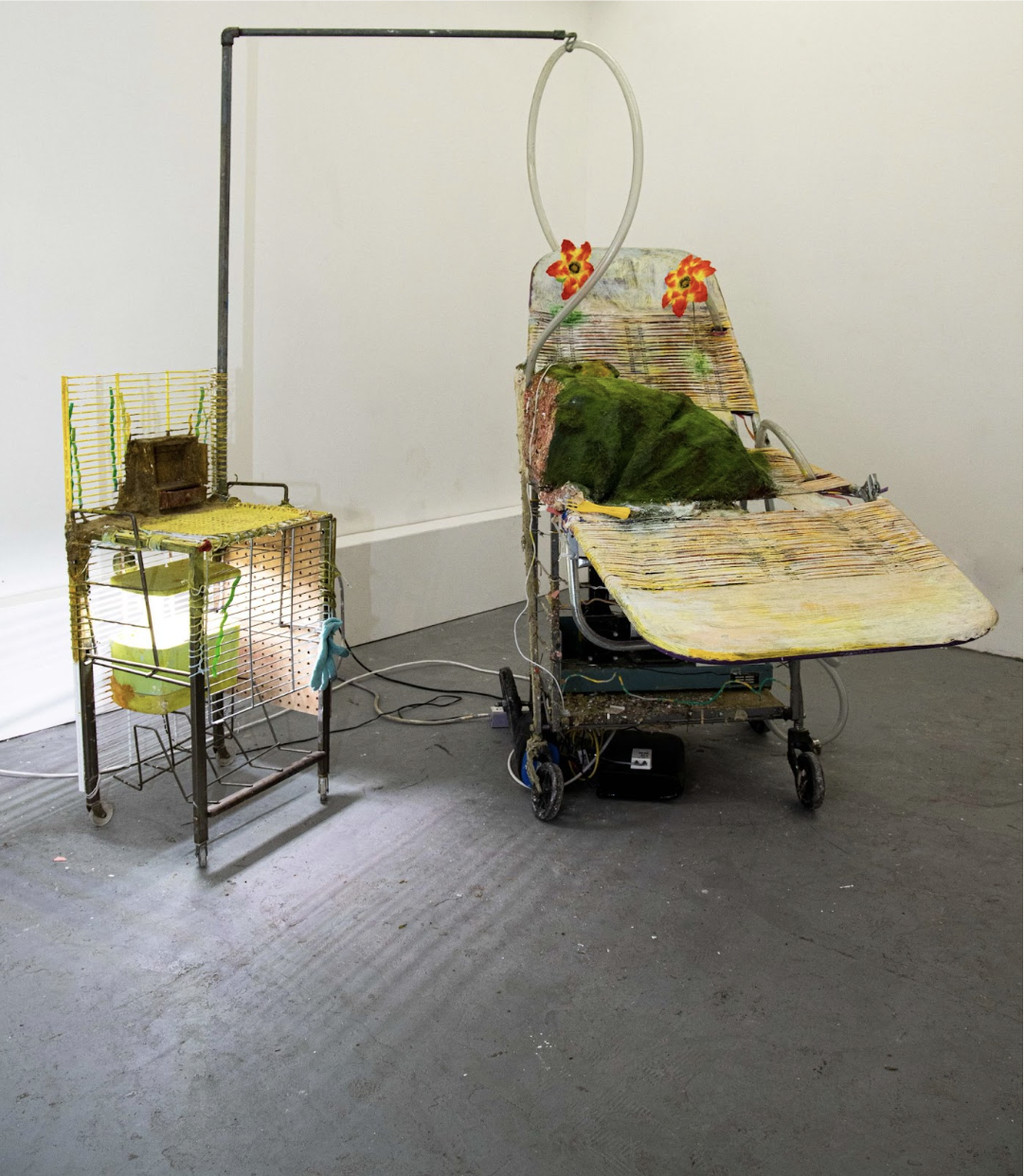 Rosalie Smith
Marriage Bed
Breathing Tube Support Station with Herb Garden
2025
Respirator, granny cart, beach chaise, artificial flowers, game controller, grass flock, debris, wires, tubes, plaster 
Grow light, herbs, rolling desk caddy. Pegboard, g