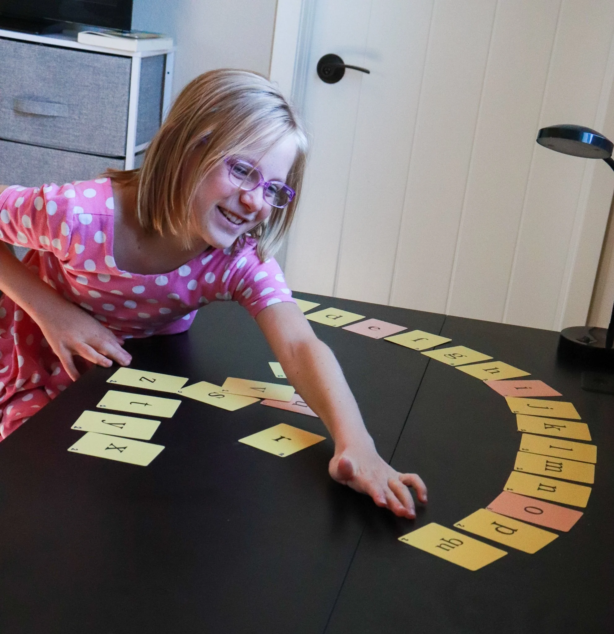 Student smiling during Orton-Gillingham reading lesson in Boulder, Colorado.