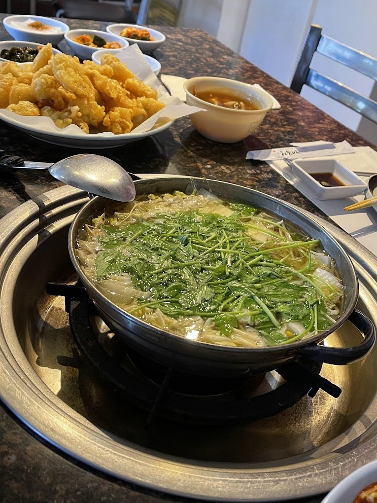 A table with hot pot and tempura.