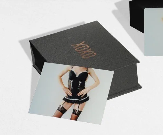 Snow-capped mountain range under a cloudy sky with brown grass hills in the foreground.