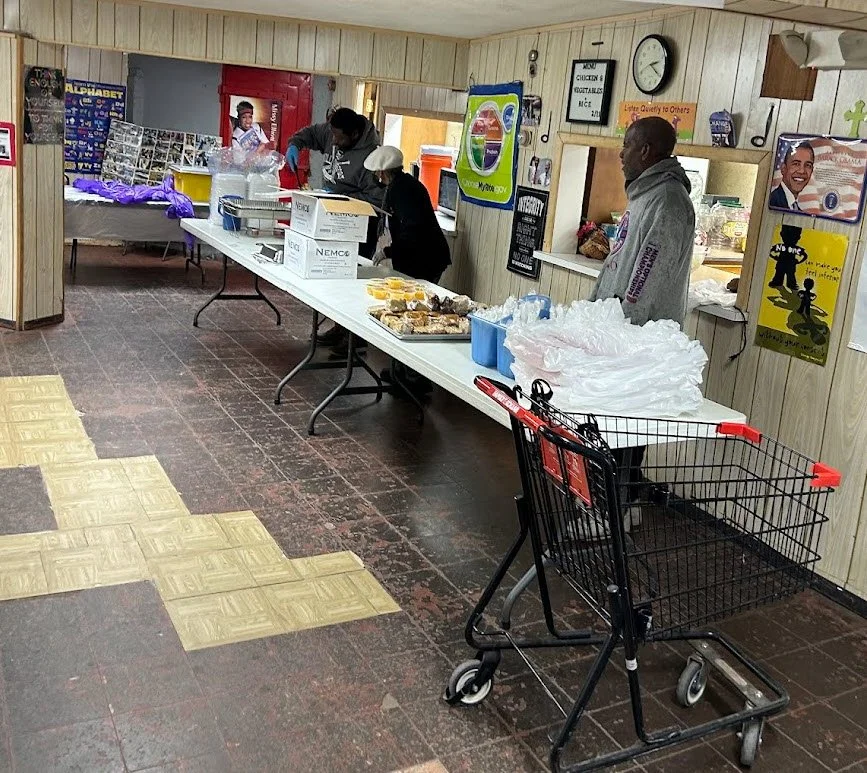 Our dedicated volunteers hard at work setting up the serving line this past Saturday.