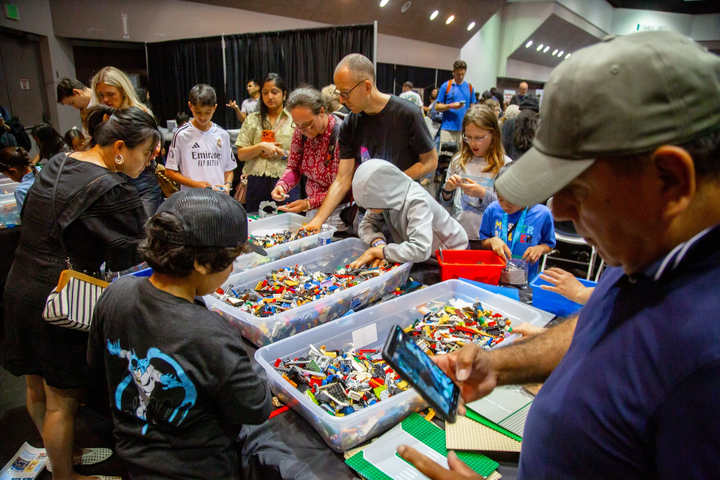 People browsing colorful LEGO bricks at an outdoor event or market, Brick Blast, LEGO Convention, Fan Event, building fun, bulk bricks 