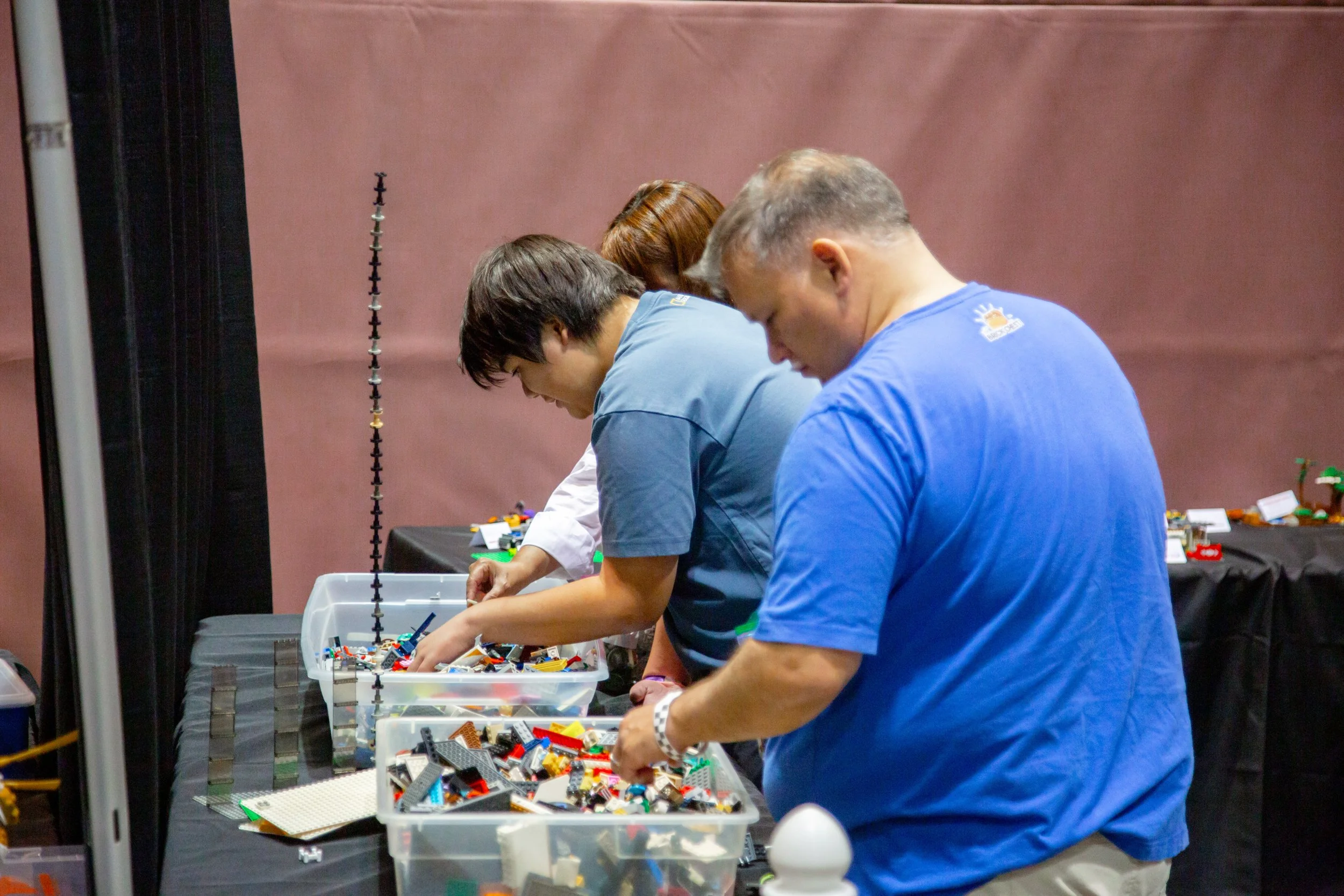 AFOLS, AFOL FANS browsing colorful LEGO bricks at an outdoor event or market, Brick Blast, LEGO Convention, Fan Event, building fun, bulk bricks
