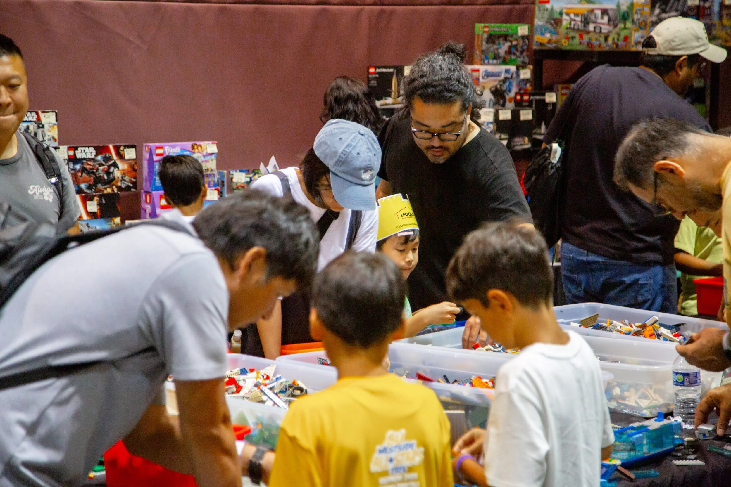 People browsing colorful LEGO bricks at an outdoor event or market, Brick Blast, LEGO Convention, Fan Event, building fun, bulk bricks