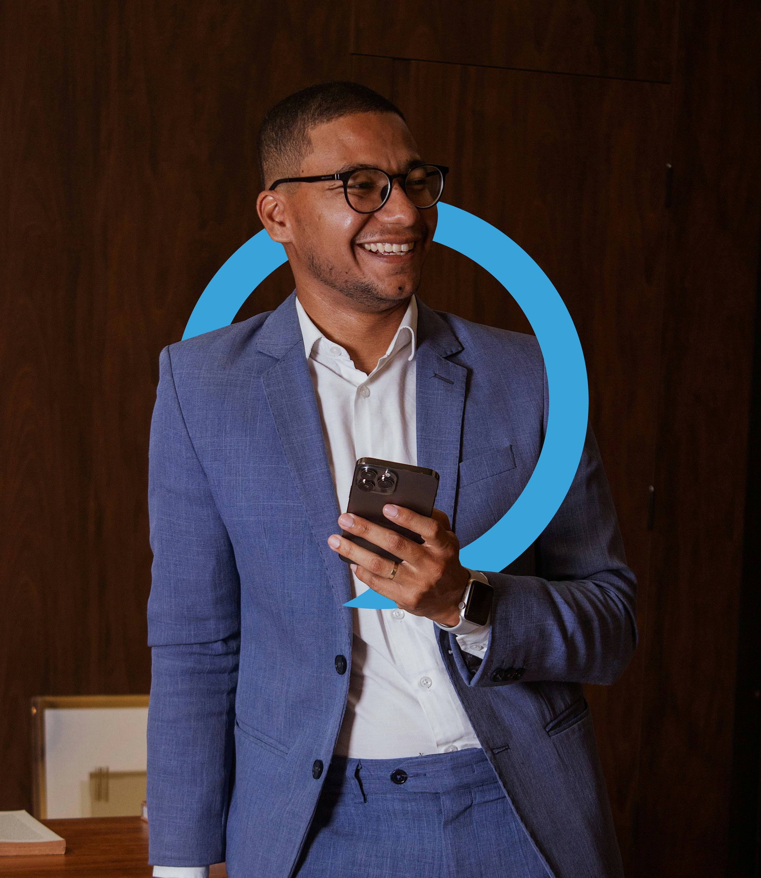 young african american man in a light blue suit and glasses holding a cell phone and smiling