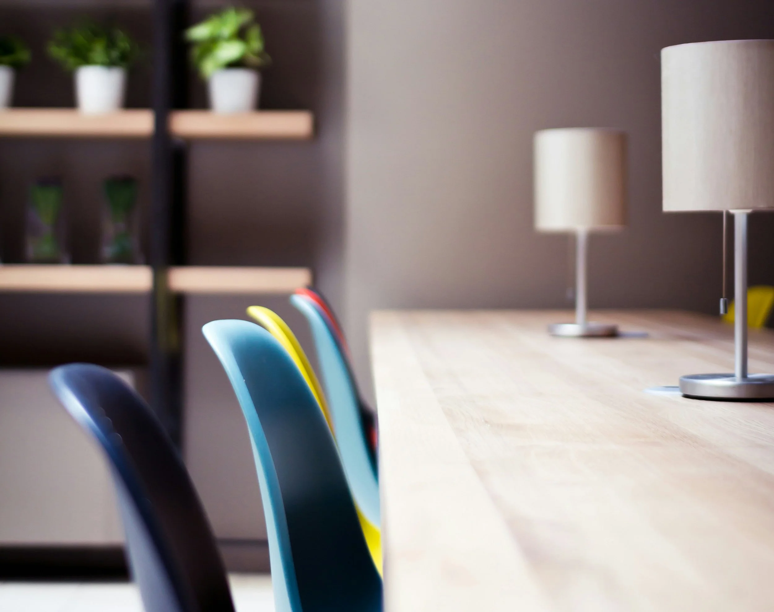 closeup of colorful chairs at a long office table