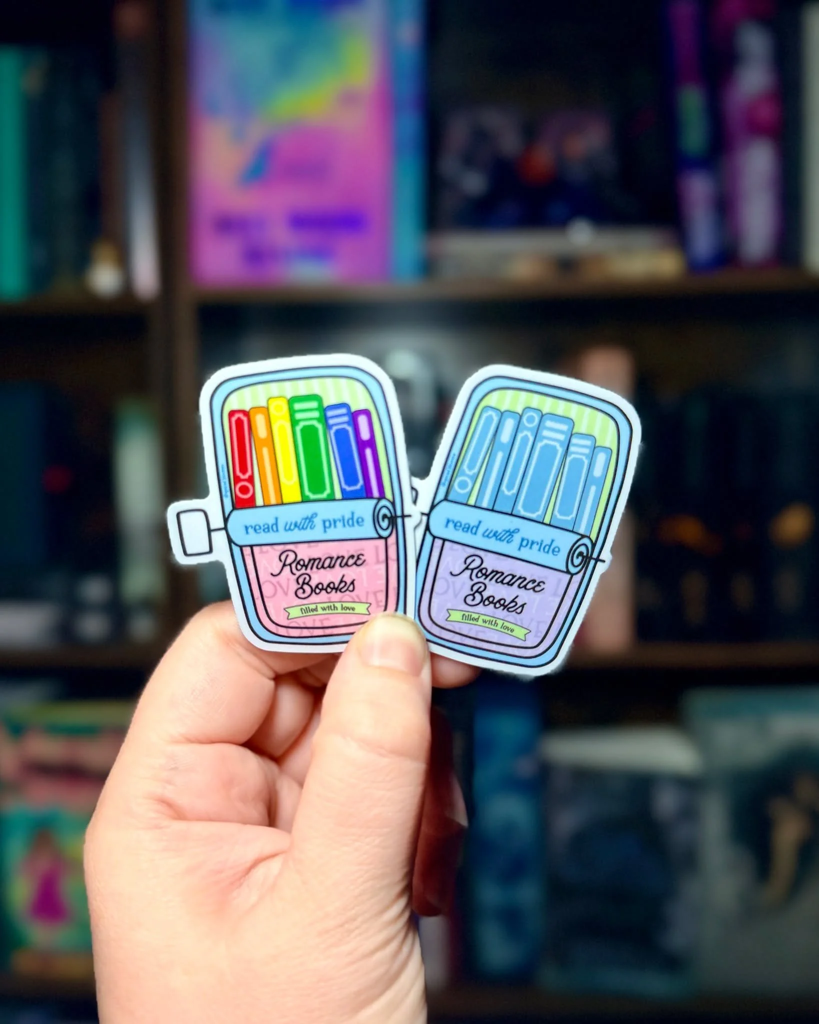 Brand new to the shop, Tinned Book Stickers - Read with Pride.

Two color ways available.
- Transgender pride flag with rainbow books
- Pastel color scheme with "fish" colored books

I will have these available this weekend at Big Wood Brew