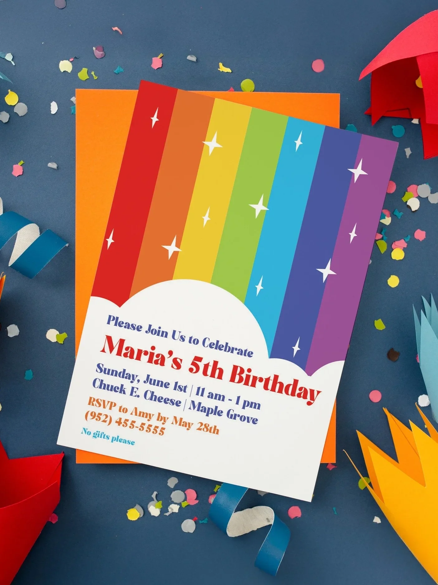 Colorful rainbow-themed birthday party invitation with confetti and party decorations.