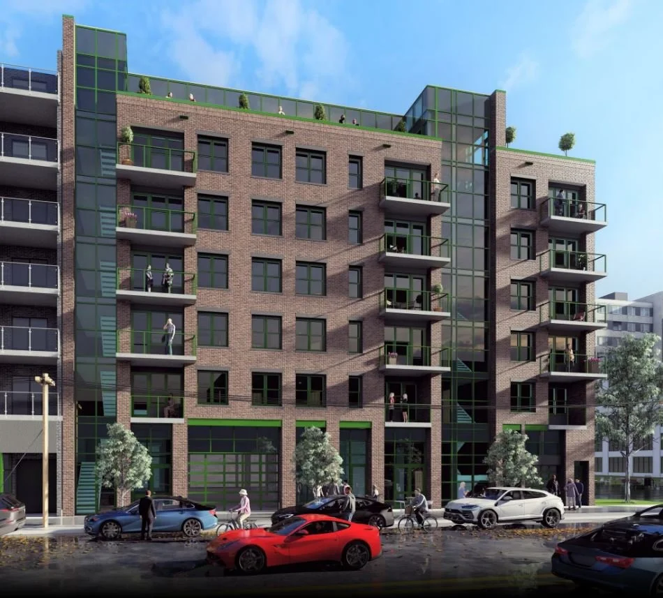Modern multi-story apartment building with brick facade, glass balconies, and rooftop garden, with cars, people, and trees in front.