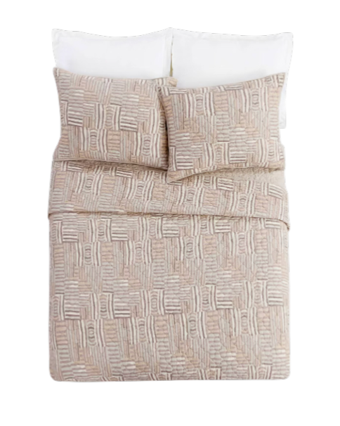 Abrazo Quilt - Bed with patterned beige comforter and white pillows