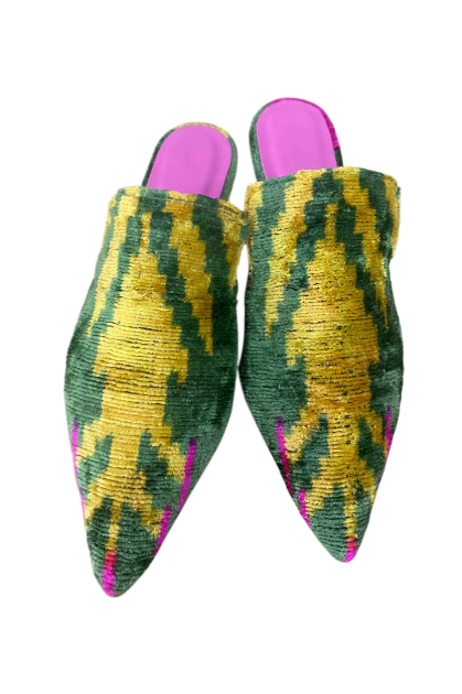 Pink slides with floral-patterned fabric covers and purple insoles.