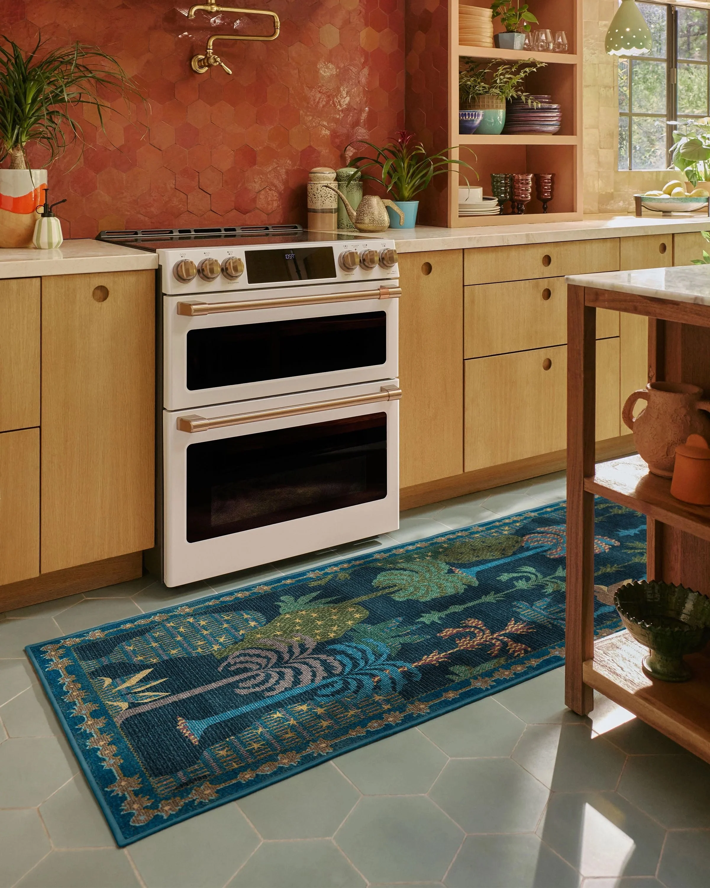 
Step into the lush, layered world of Jungalow. The Palmistry Midnight Rug is inspired by nature walks and the tactile richness of woven tapestries, translated from Justina Blakeney's original painting. Rendered in blue, green, olive, seafoam, red, a