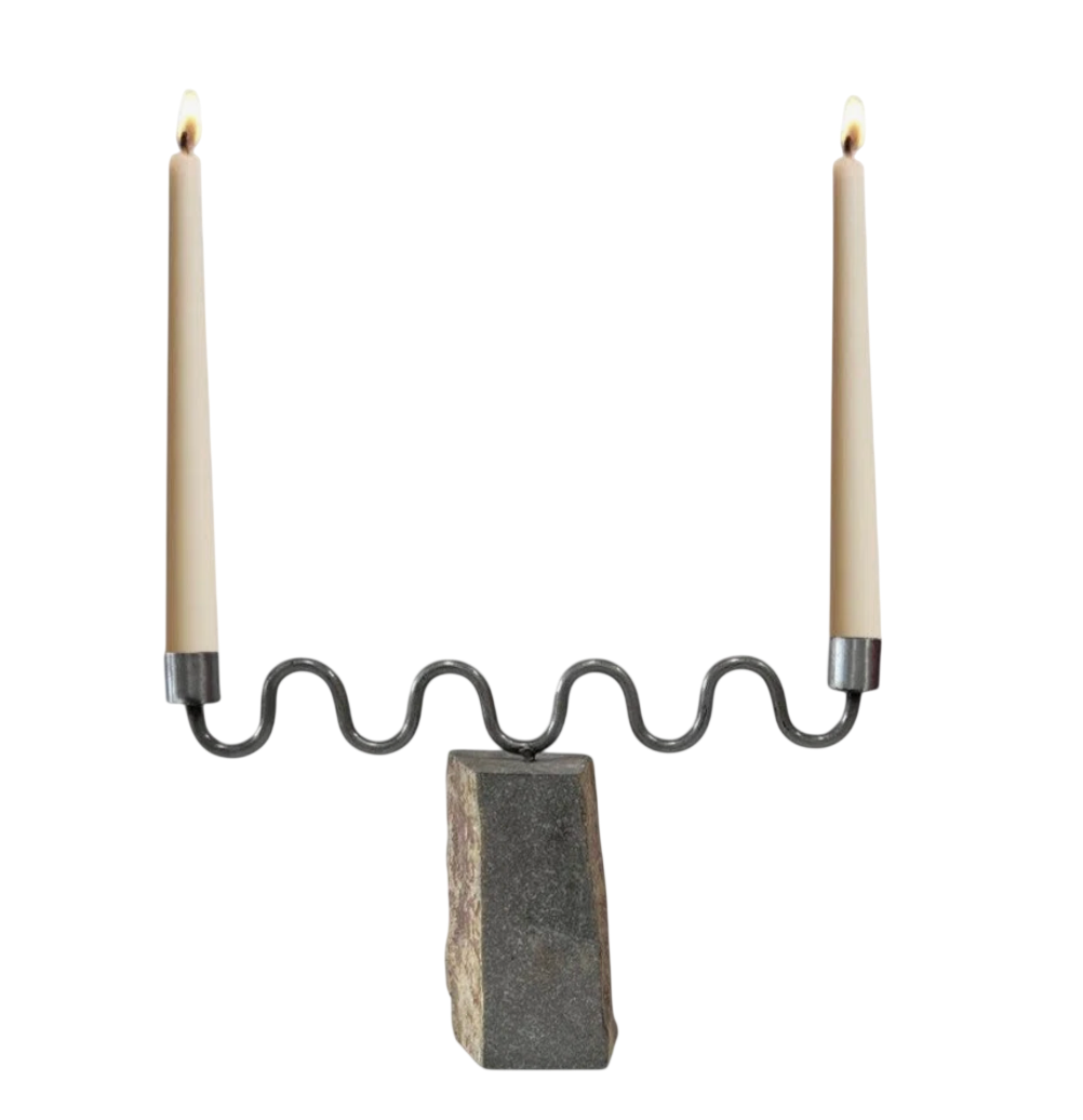 The Aria Candle Holder is made using river rock and raw iron. Both stone and metal craftsmen from Sabana Grande Honduras collaborate to create this collection. Up to 8” taper.