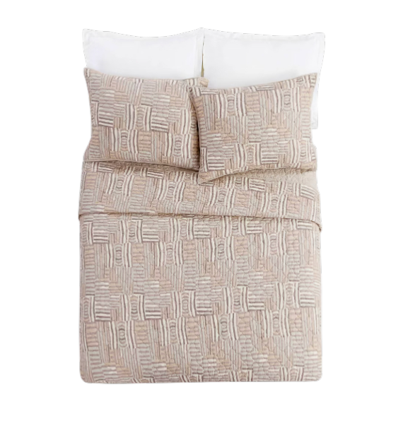 Abrazo Quilt - Bed with patterned beige comforter and white pillows