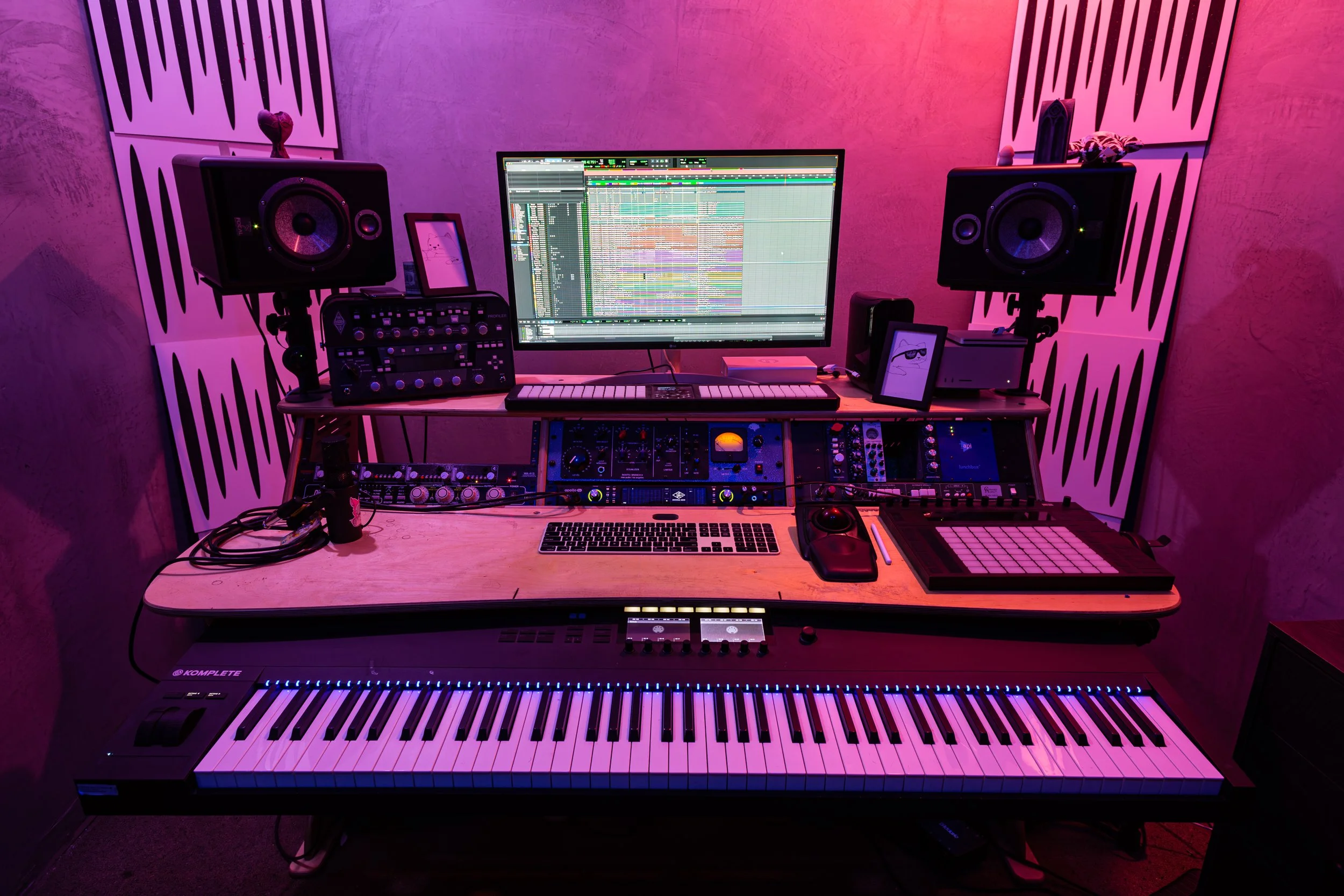 El Segundo professional music production studio desk setup with MIDI controller, analog mixing console, studio monitors, and DAW screen for audio recording, mixing, and sound design