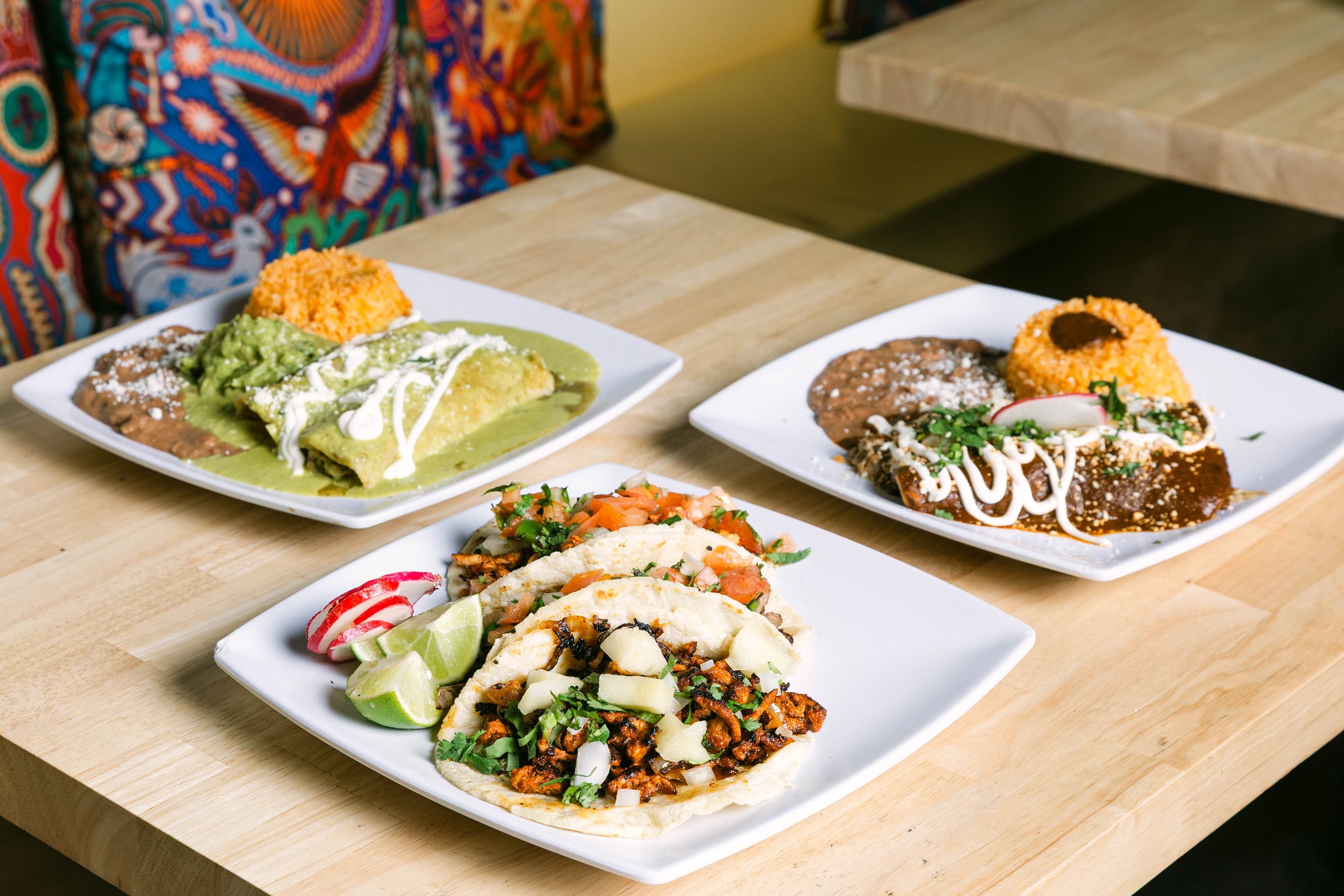 Plate of authentic Mexican tacos with seasoned meat, fresh cilantro, onions, and salsa served at Poblano Pepper Restaurant in Portland, Oregon