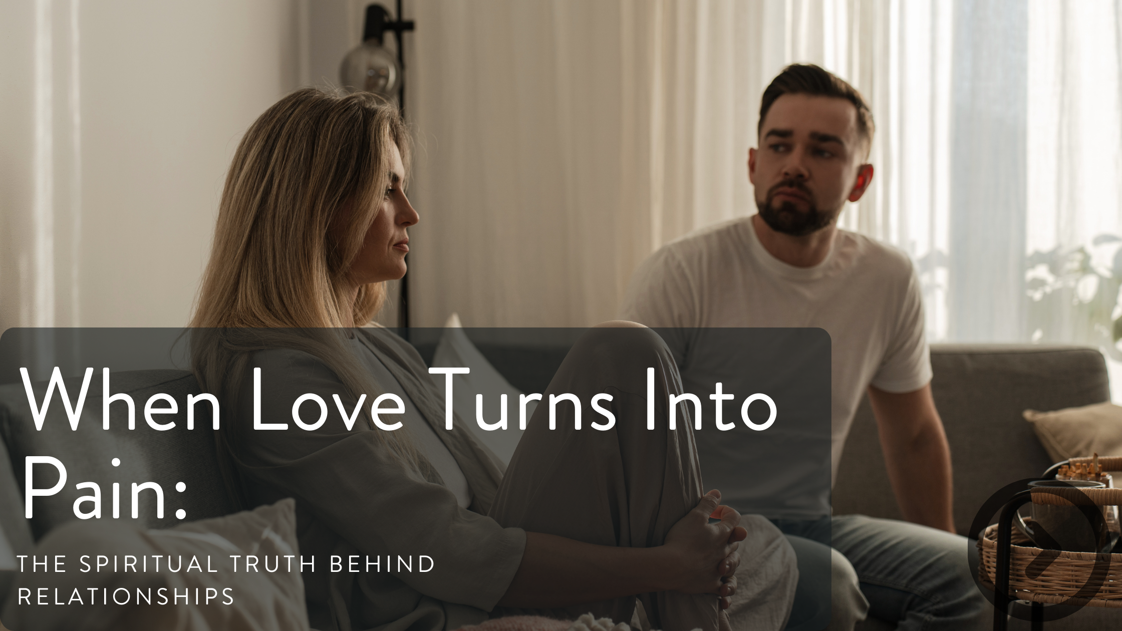 A couple sitting on a couch having an intense and serious conversation in a living room with natural light.