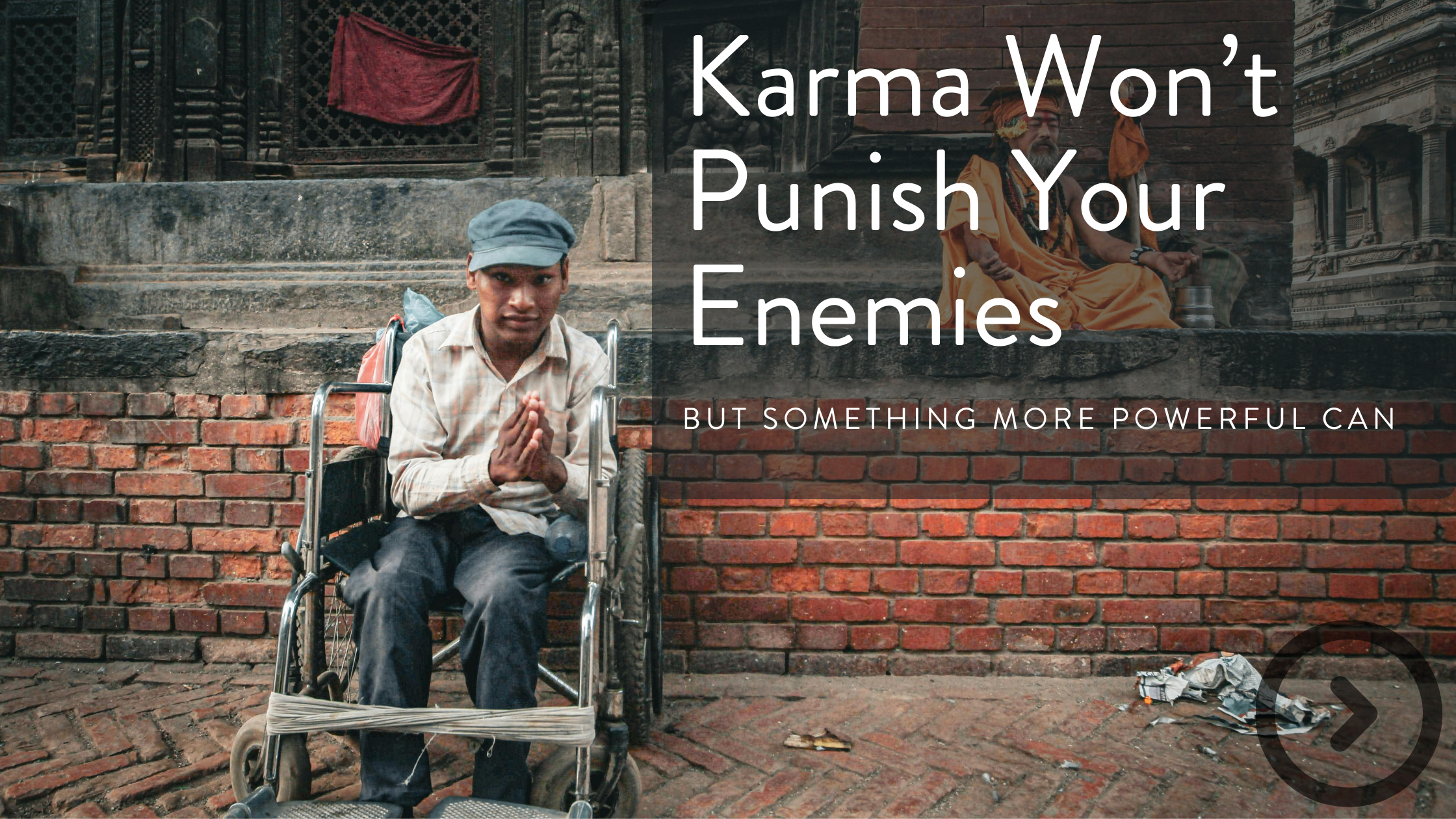 A man in a wheelchair with hands folded in prayer, sitting in front of a brick wall with a temple or historic building, with a large statue or sculpture in the background.