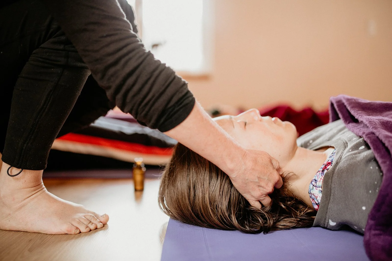 Fiona MacLeod working with a student on retreat in Portugal, neck release for shavasana