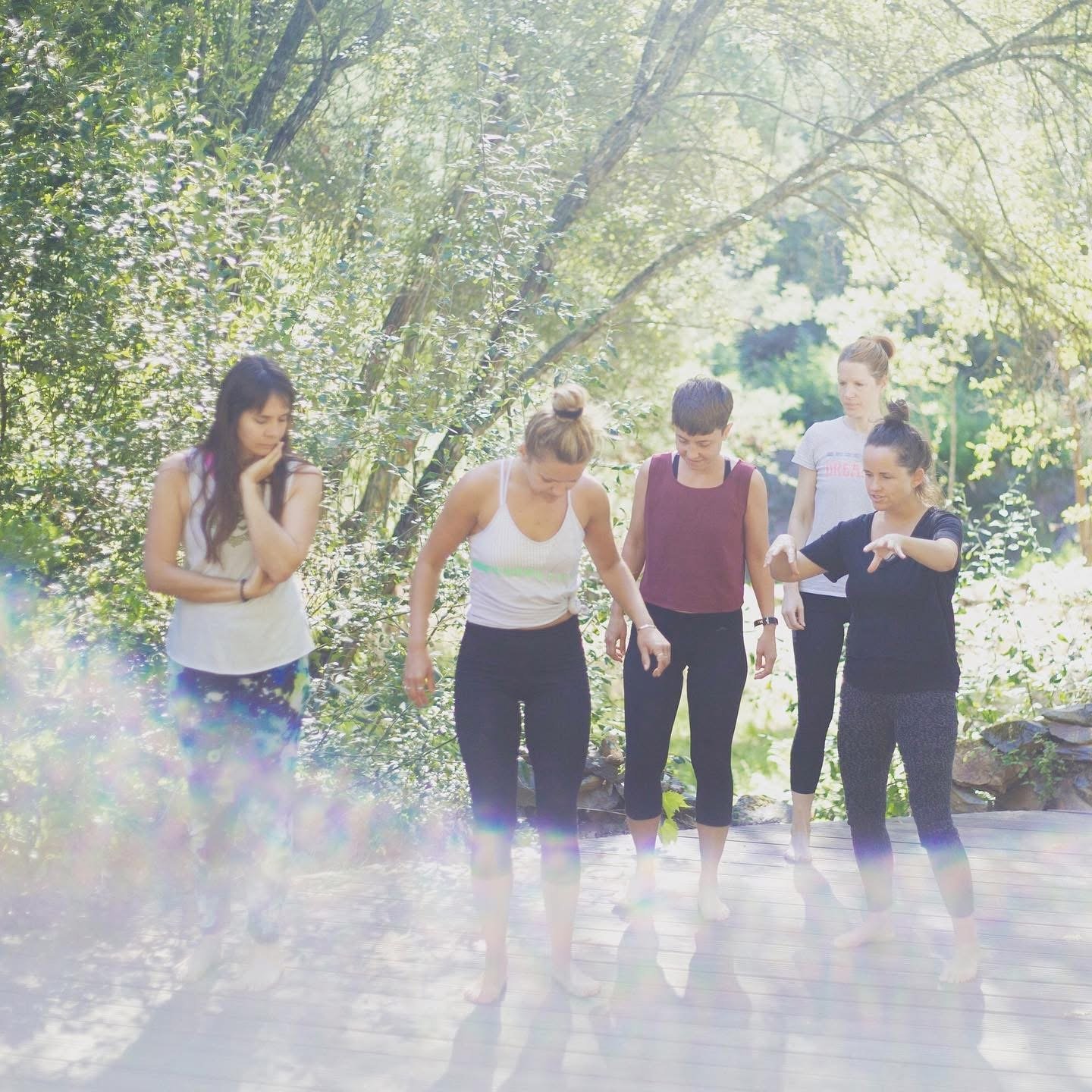 A group of women outside learning about grounding, discussing the earth element and our feet