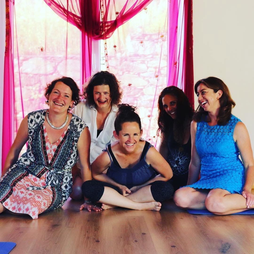 A group of women laughing on a yoga retreat, Fiona MacLeod at centre.