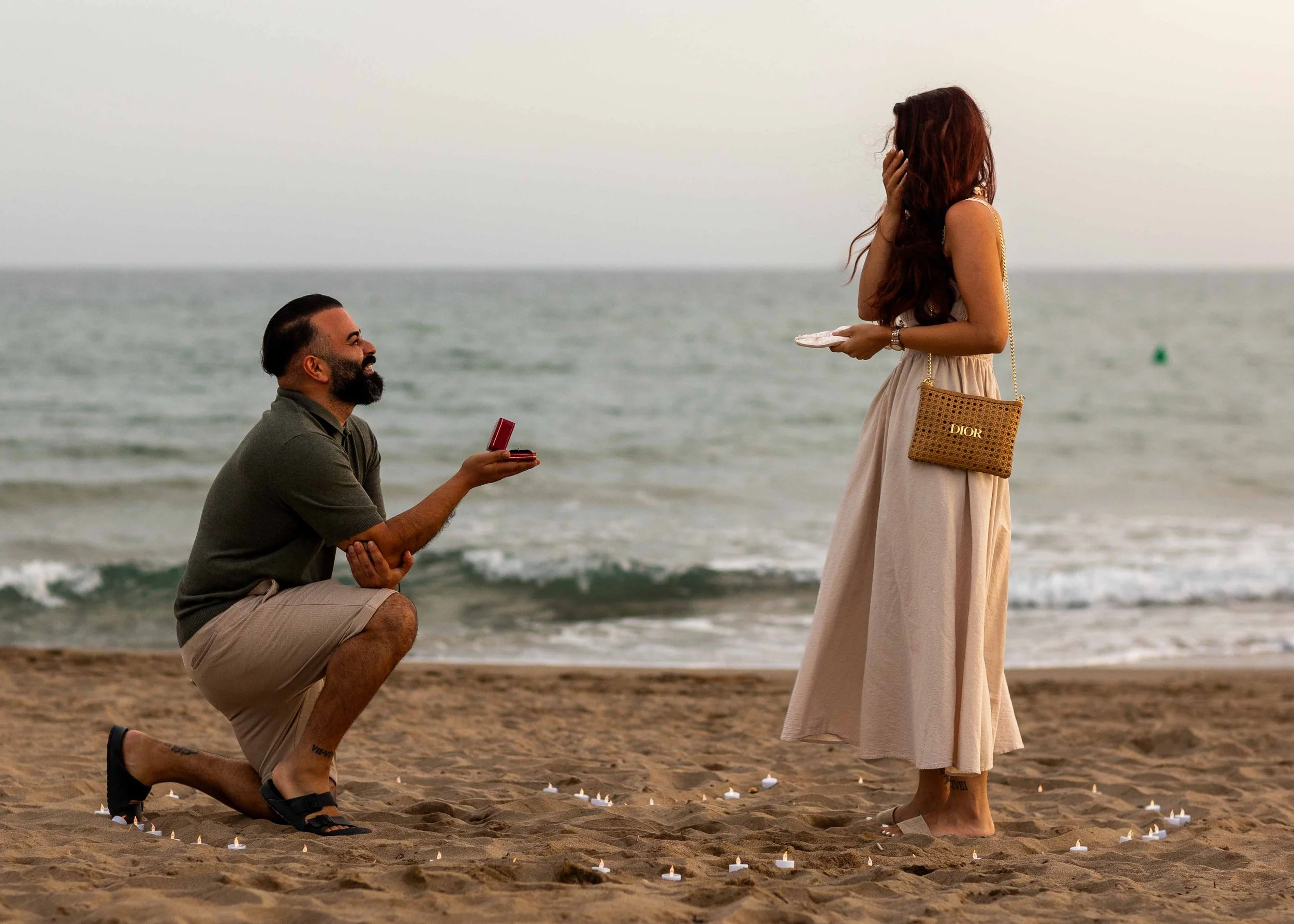 Romantic candlelit beach proposal near Barcelona as Enisa discovers the surprise