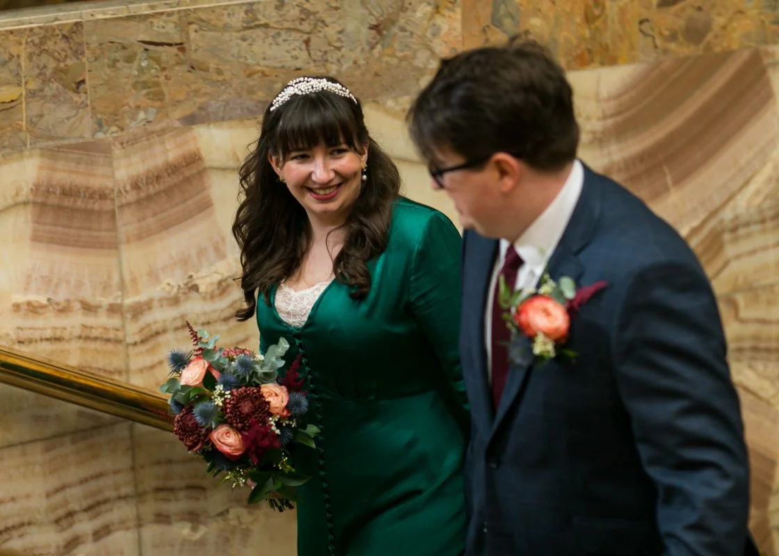 Close-up of wedding rings on a lace bridal bouquet